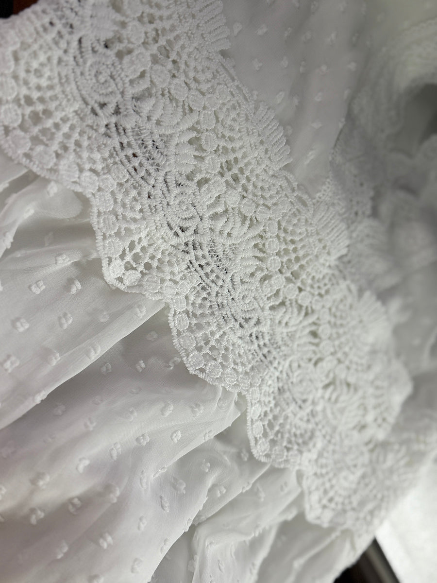 White textured fabric with lace trim