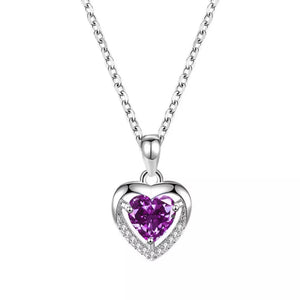 Elegant heart pendant necklace with purple zircon and clear accent stones on a silver chain.