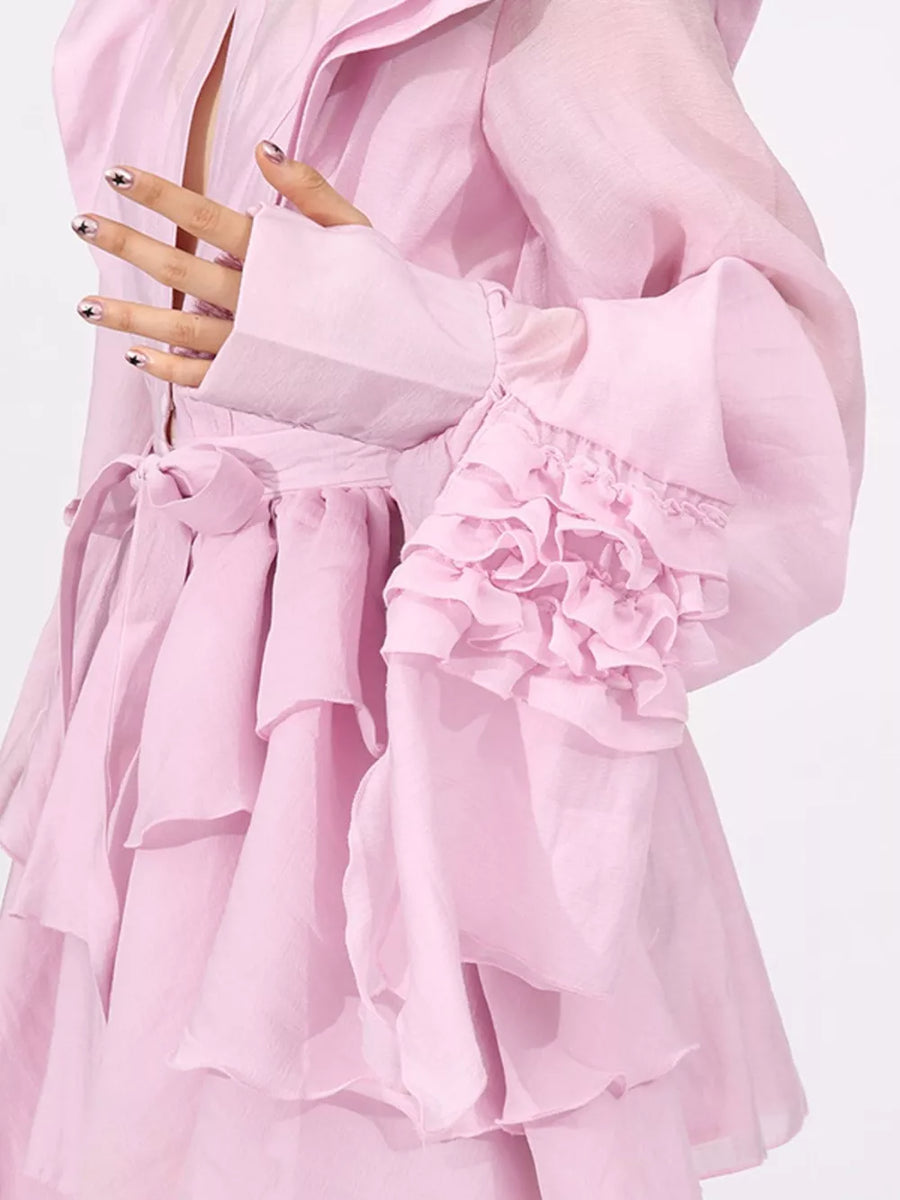Pink tiered ruffle mini dress with button-down detail and ruffled bell sleeves.