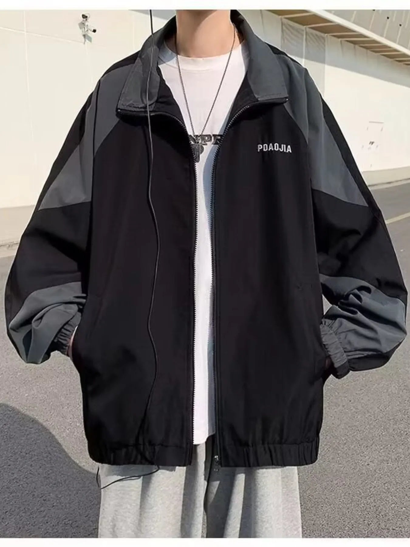 Plus-size black and grey two-tone windbreaker jacket with zip front and text detail.