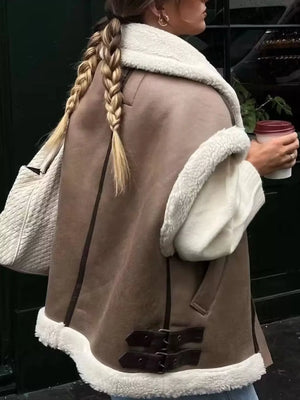 Brown faux shearling vest coat with white sherpa trim and buckle details.