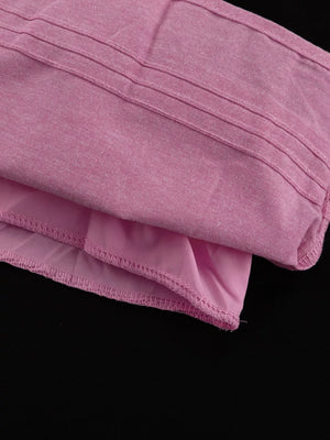 Pink textured fabric top with ribbed detail and ruffled hem.