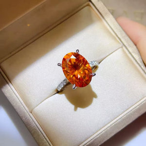 ring in orange featuring oval cut stone and fitted fit