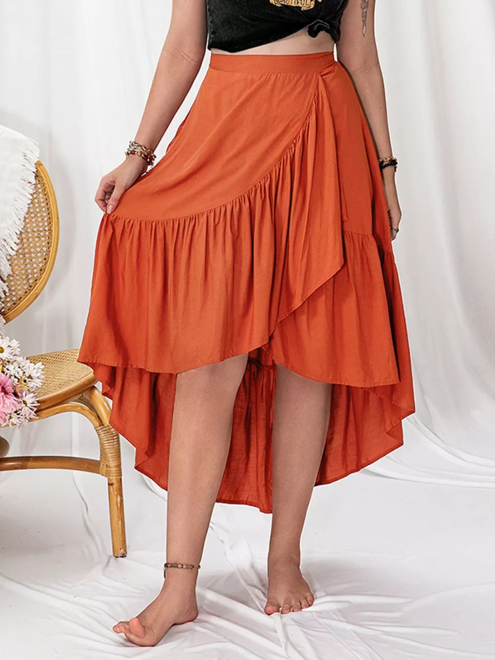Chic ruched orange high-low skirt with ruffle detail, perfect for curvy women.