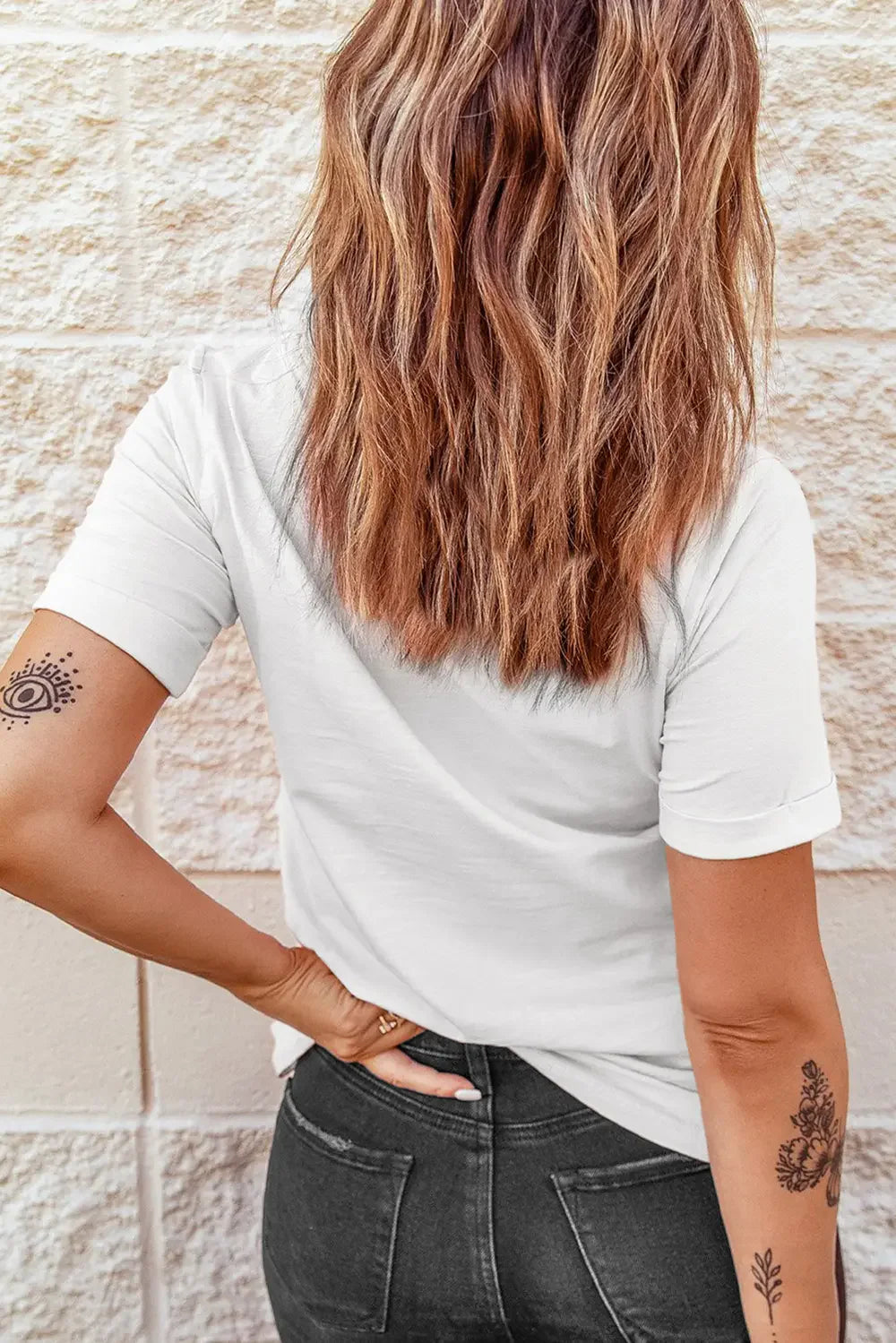 White casual t-shirt with rolled sleeves and a relaxed fit, shown from the back.