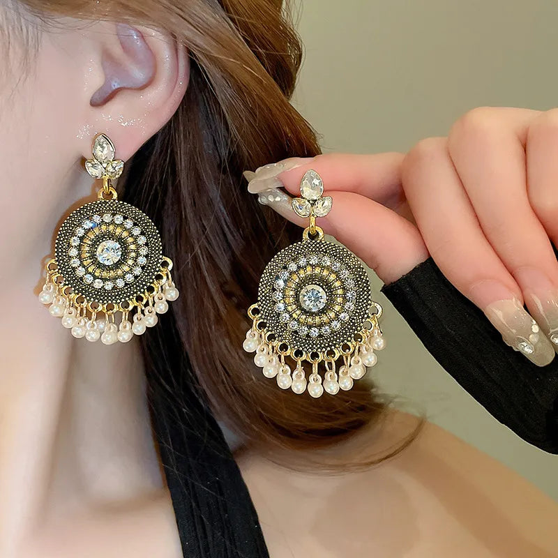 Beaded medallion drop earrings with pearl accents and clear crystals.