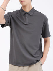 Dark gray textured performance polo shirt with short sleeves and a two-button placket.