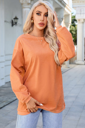 Orange corduroy relaxed fit sweatshirt with crew neck and long sleeves.