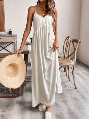 Effortless V-neck maxi dress in natural linen blend, with adjustable spaghetti straps and a gathered empire waist.
