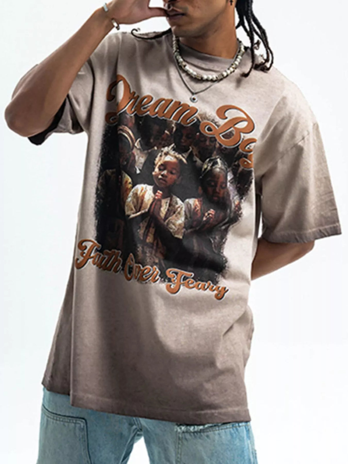 Khaki graphic t-shirt with puff sleeves and a "Dream Big Faith Over Fear" print.