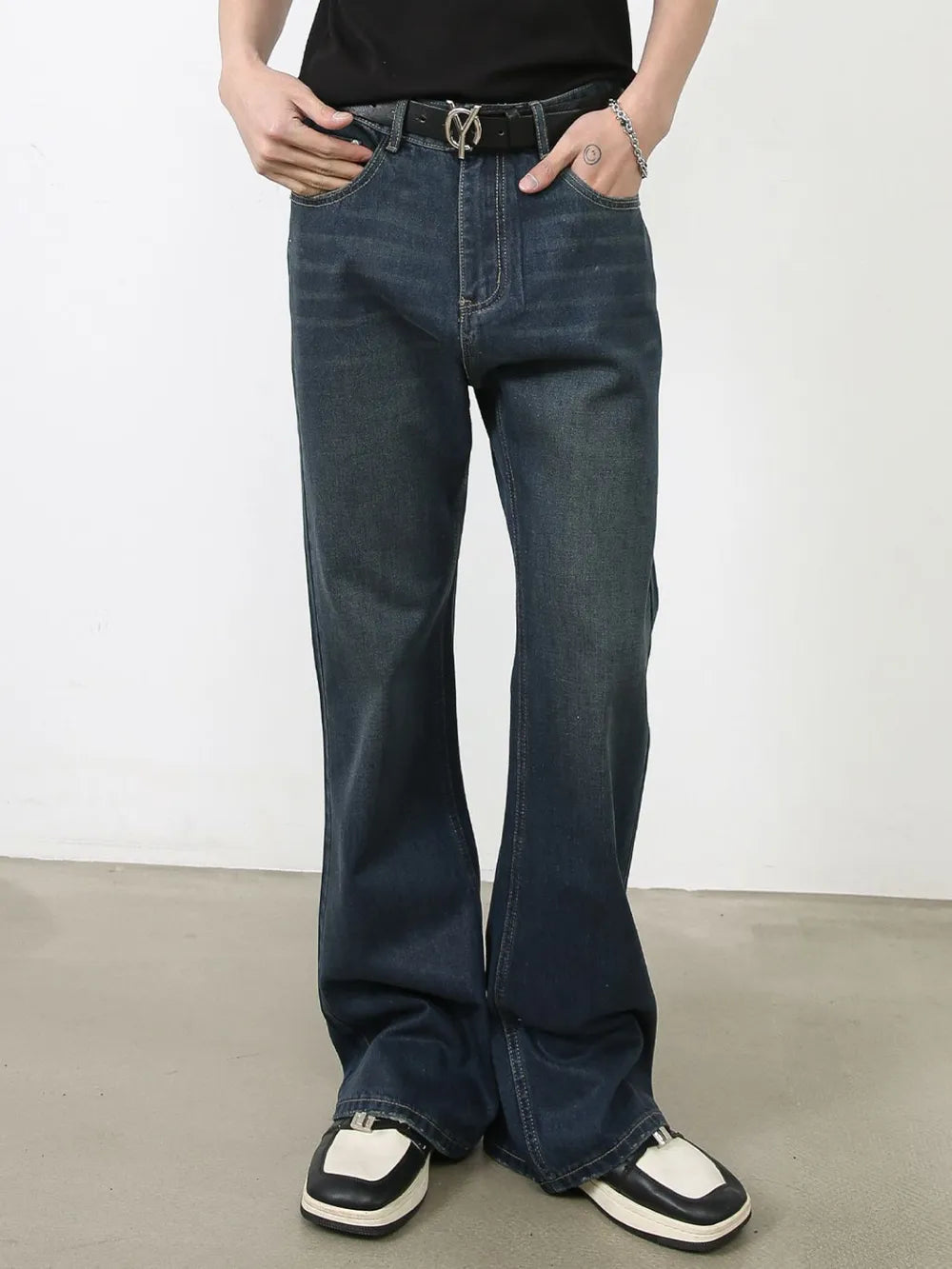 Dark flared denim jeans with subtle fading and bootcut leg