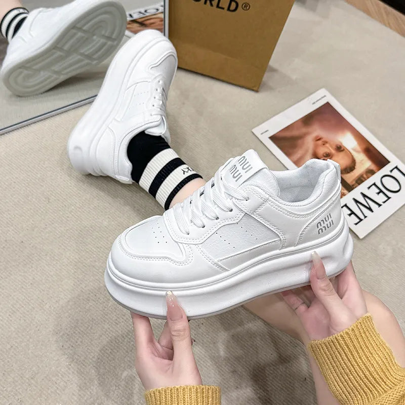 White platform court sneakers with contrast detail and logo accents.