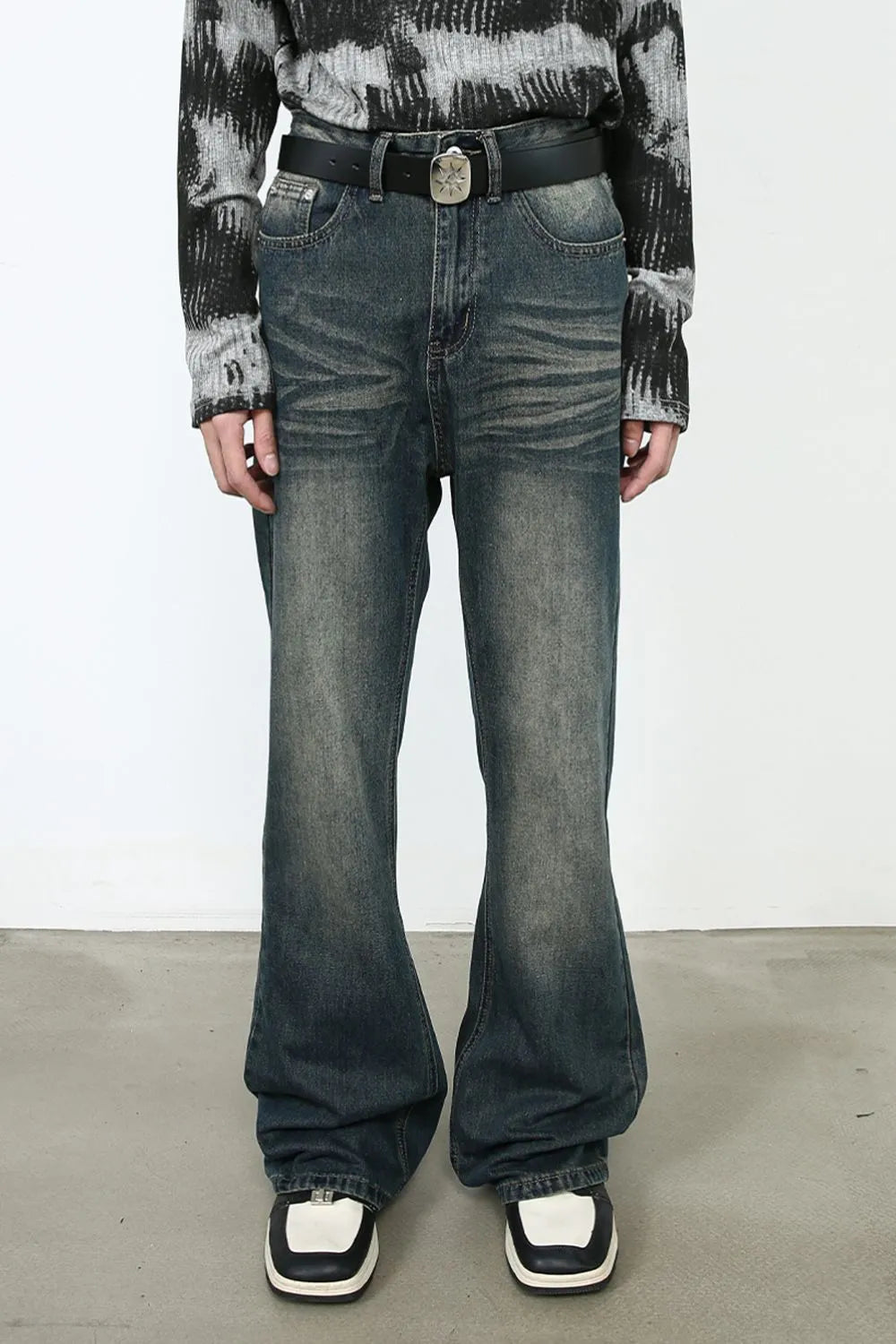 Faded flare denim jeans in dark vintage wash with a bootcut leg.