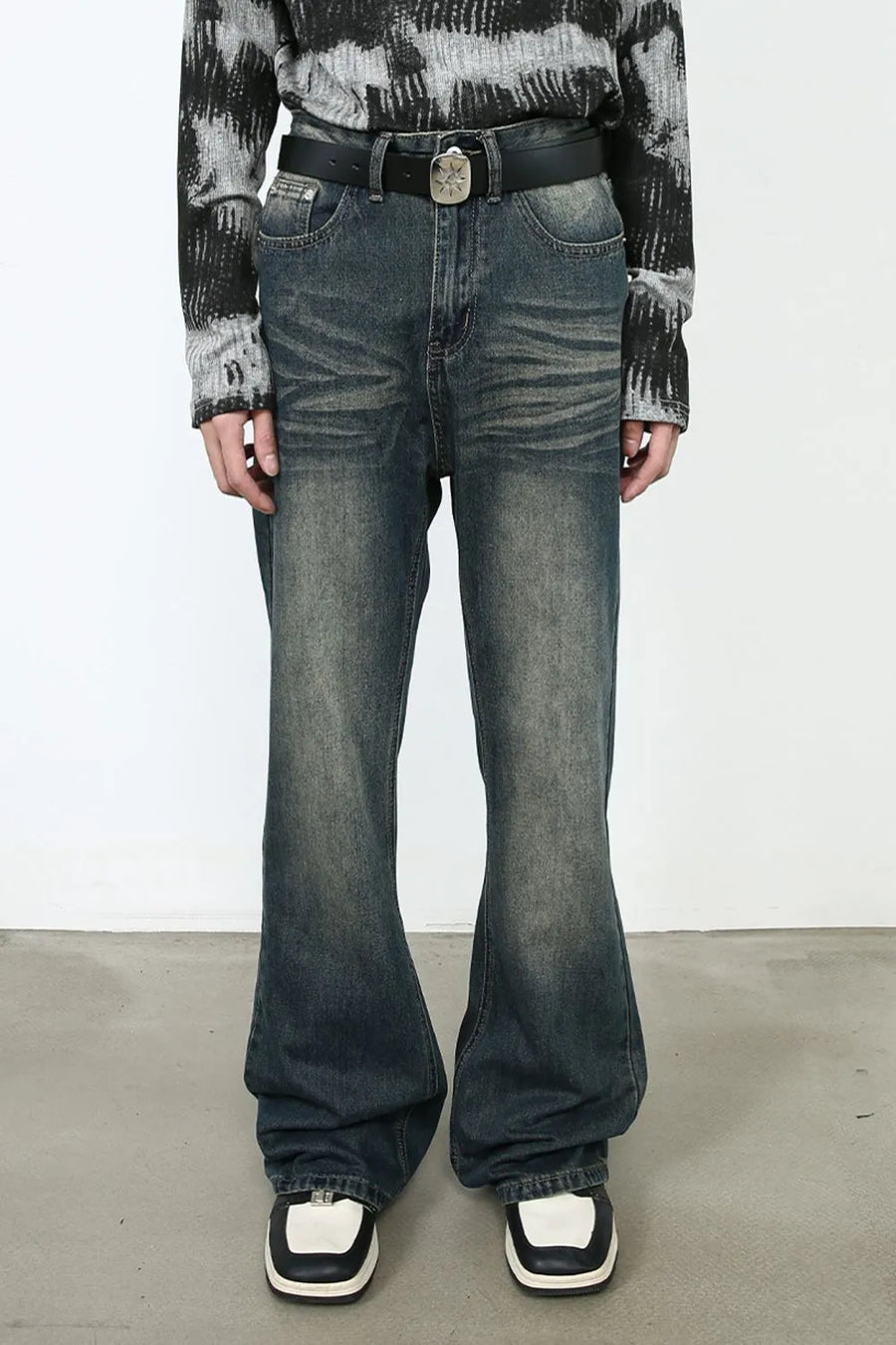 Faded flare denim jeans in dark vintage wash with a bootcut leg.