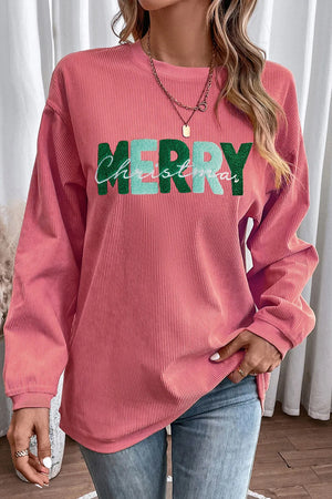 Burnt coral corduroy sweatshirt with "Merry Christmas" graphic.