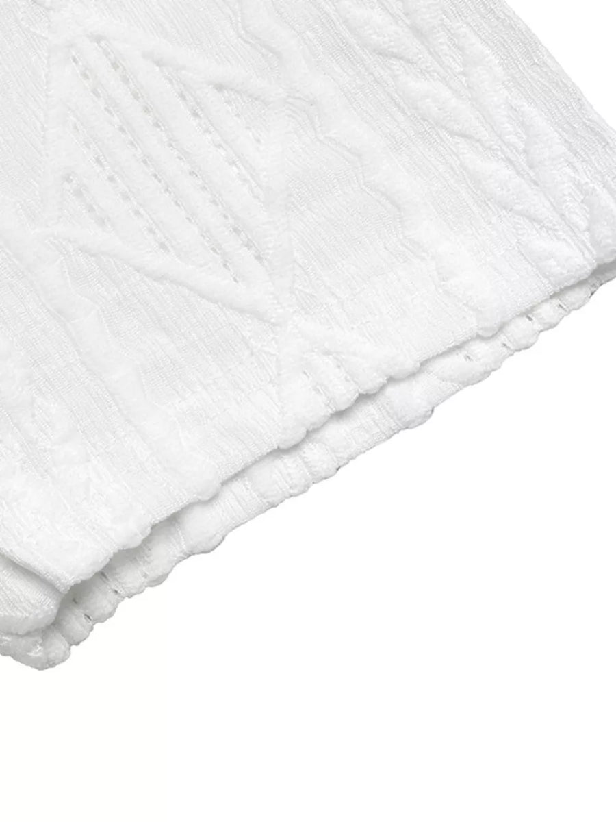 White textured knit maternity t-shirt with subtle diamond pattern and bow detail.
