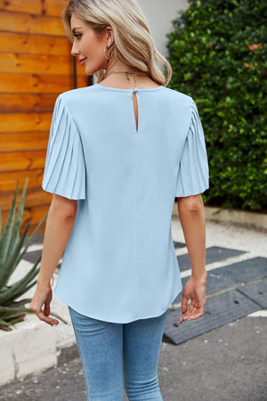 Pastel blue blouse with short pleated sleeves and keyhole back detail.
