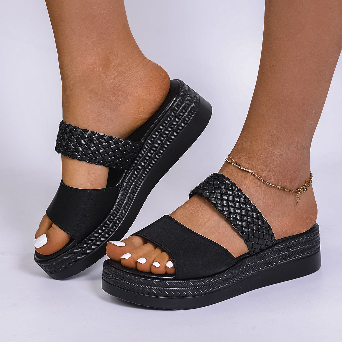 Chic black two-strap platform sandals with braided detail and chunky sole.