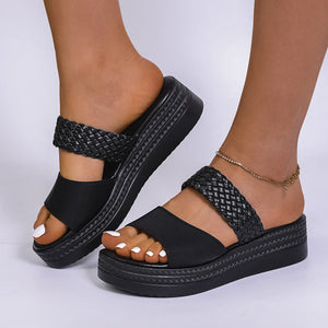 Chic black two-strap platform sandals with braided detail and chunky sole.