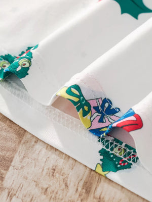 White children's pajama set with festive Christmas print detail.