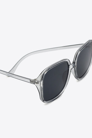 Retro-infused square frame sunglasses with clear frames and dark lenses.