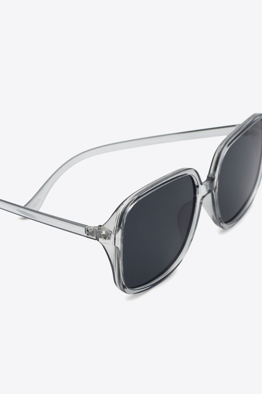 Retro-infused square frame sunglasses with clear frames and dark lenses.
