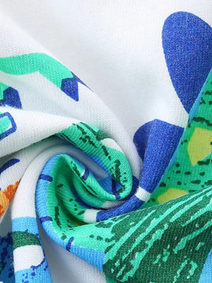 Children's cotton crew neck t-shirt with a colorful dinosaur print in blue, green, and orange.