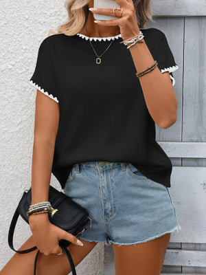 Black ribbed short-sleeve sweater with white contrast trim neckline and cuffs.