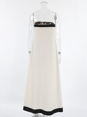 Beige cotton blend tube maxi dress with black trim and spaghetti straps.