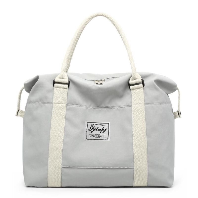Light Gray large capacity travel duffel bag with cream straps and a front logo patch.