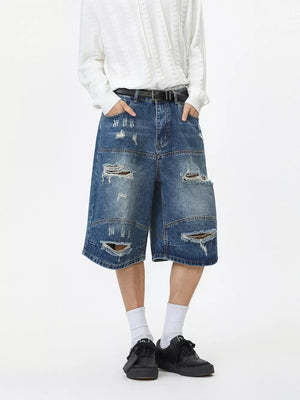 denim shorts in medium wash blue featuring distressed and loose fit