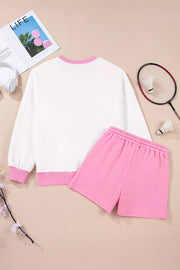 White cotton sweatshirt with pink trim and matching pink shorts, a comfortable women's activewear set.