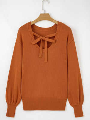 Caramel acrylic blend sweater with bow detail at neckline and drop shoulders.