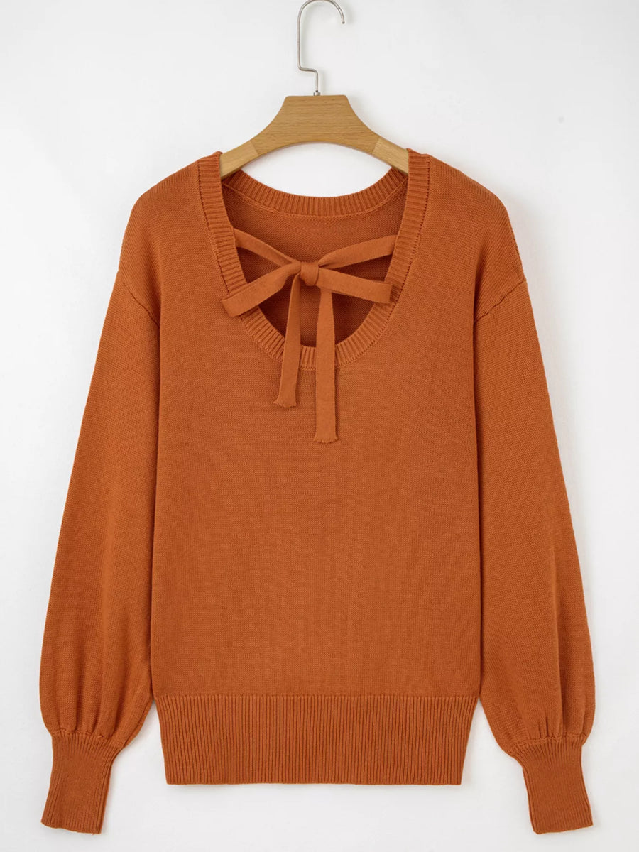 Caramel acrylic blend sweater with bow detail at neckline and drop shoulders.