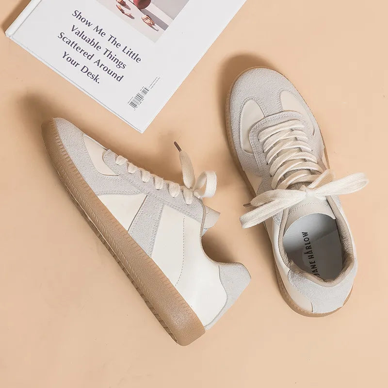 Beige and white leather panel sneakers with lace-up closure and gum sole.