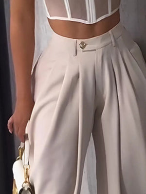 Light Khaki sculptural pleated high-waisted pants with button detail.