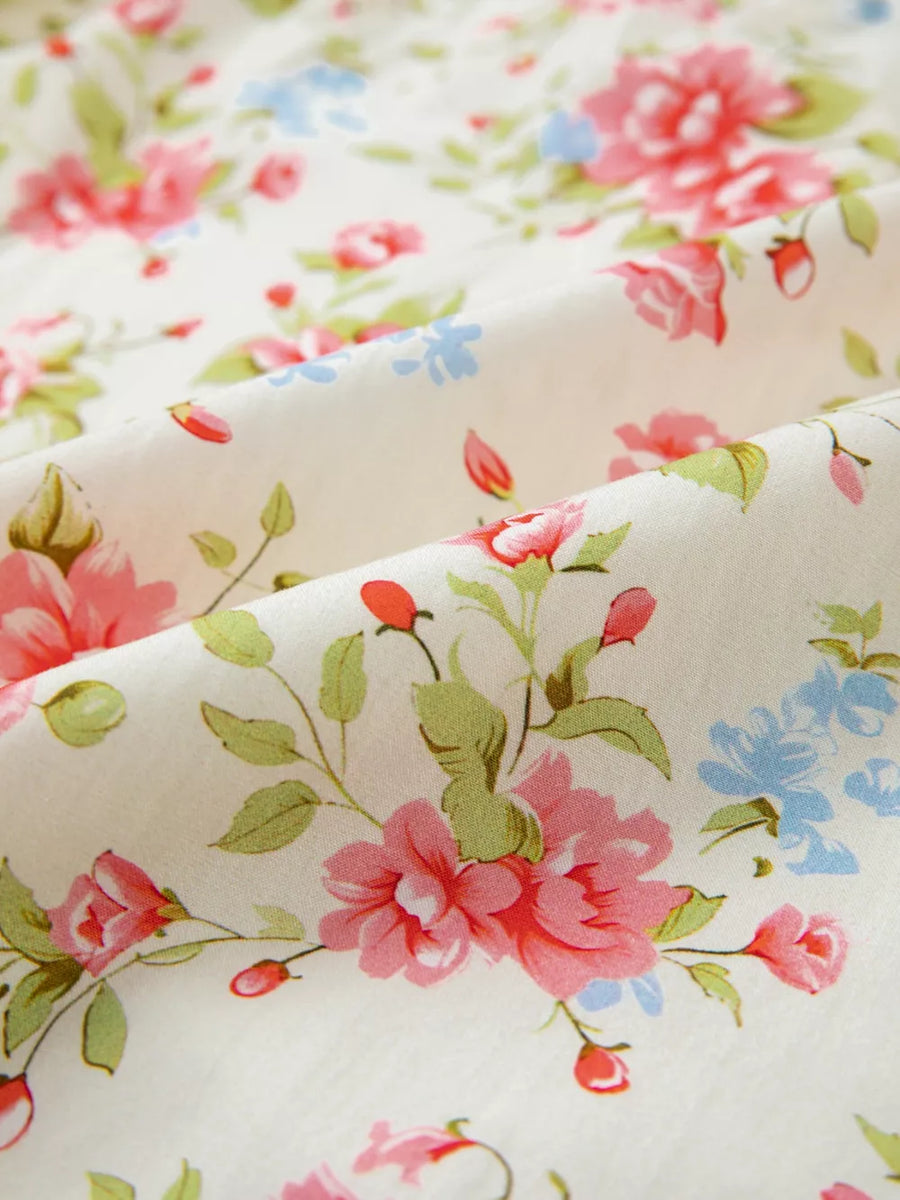 Floral pocketed puff sleeve dress in cotton with a vintage floral print.