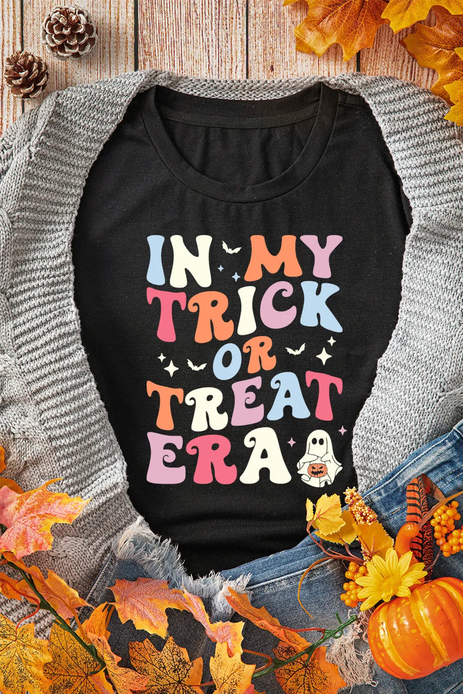Black graphic t-shirt with colorful "In My Trick or Treat Era" text and a ghost graphic.