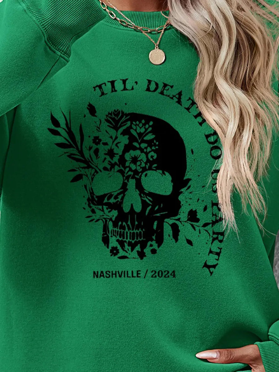 Green sweatshirt with floral skull graphic and text.