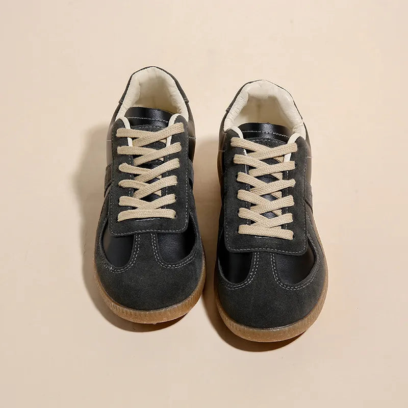 Black suede and leather retro trainers with beige laces and gum soles.