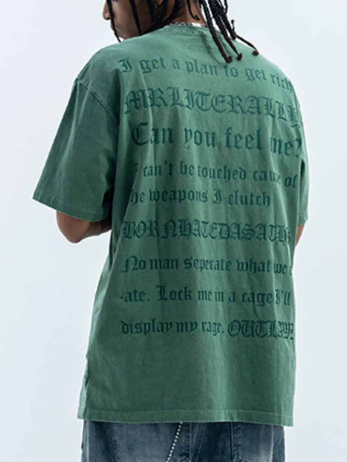 Green oversized graphic tee with gothic text print, 100% cotton, short sleeves.