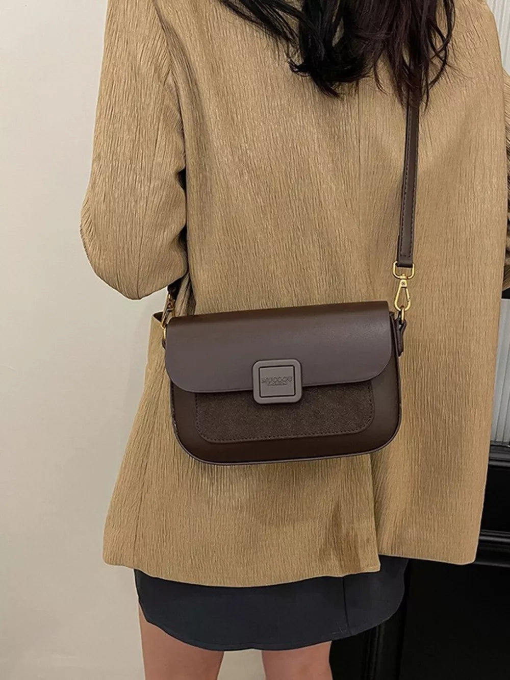 Chic two-tone crossbody bag in coffee brown with suede panel and square clasp.