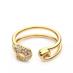 Gold double band ring with zircon embellishments on safety pin detail