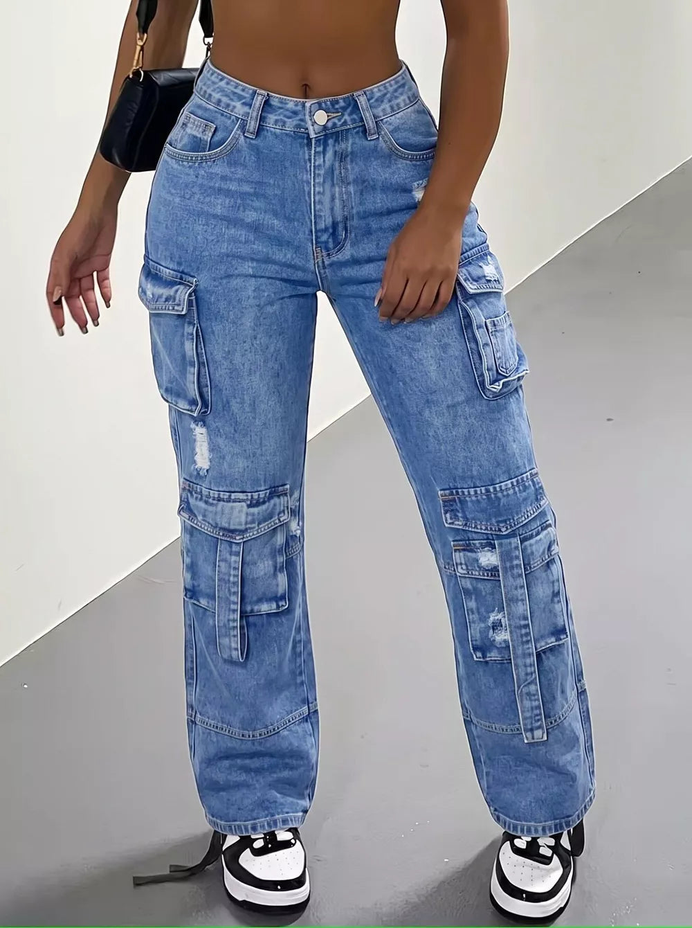 cargo jeans in light wash blue featuring distressed and relaxed fit