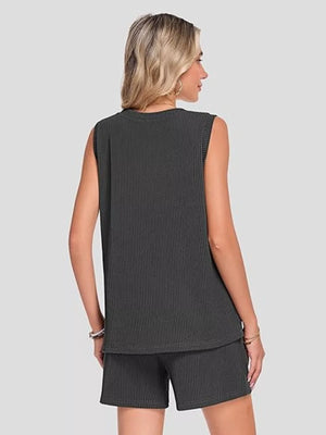Black ribbed knit set with sleeveless top and shorts, featuring pockets.