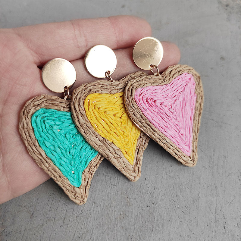 Woven heart earrings in aqua, yellow, and pink with gold posts.