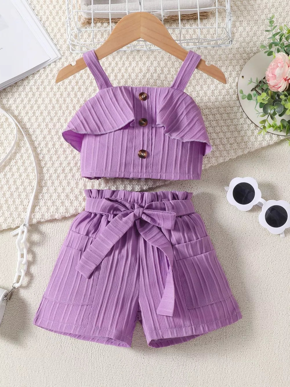 Violet ruffled ribbed two-piece toddler set with buttoned crop top and tie-waist shorts.