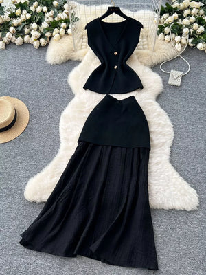 Black sheer two-piece set with V-neck sleeveless top and button details, paired with a flowing skirt.