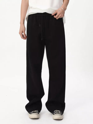 Black relaxed fit sweatpants with adjustable drawstring waist and wide leg