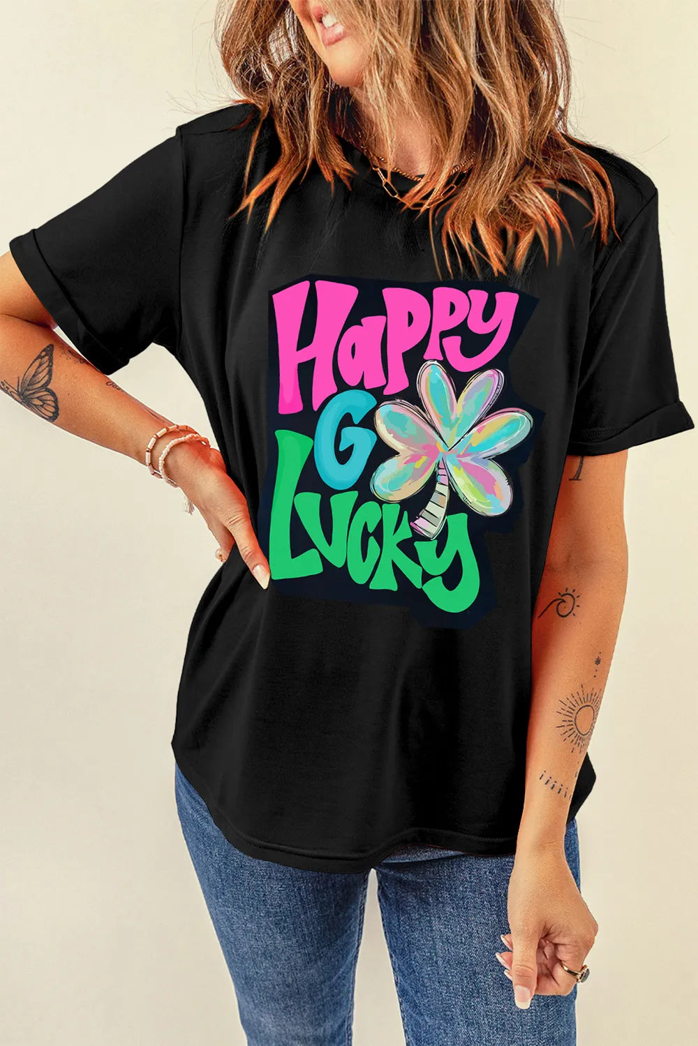 Black graphic tee with rolled sleeves and "Happy Go Lucky" clover design